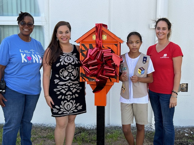Group of people with little library.